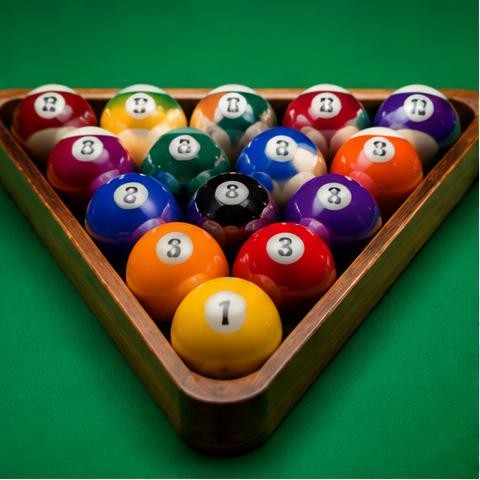 Pool balls in a wooden triangle on green felt